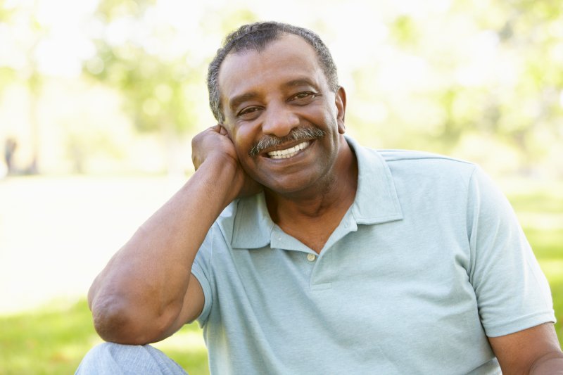 Older patient smiling with their Invisalign